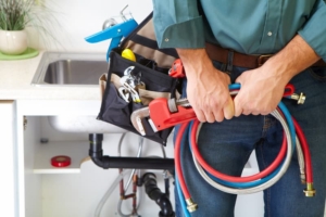 Professional plumber with tools to service homes and businesses in Portland, OR