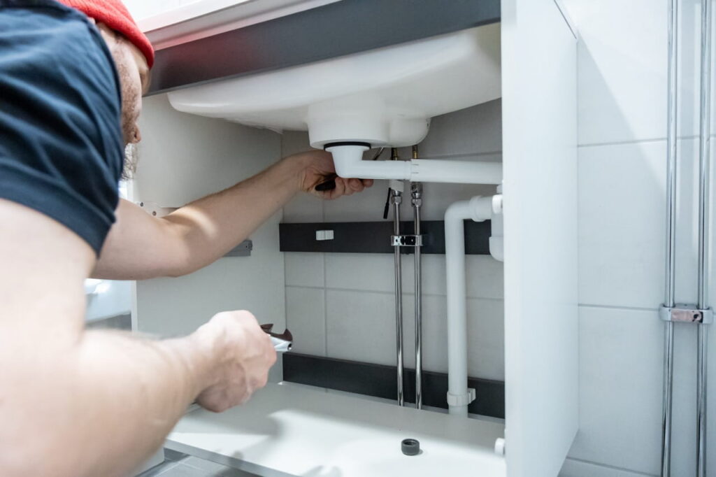 Plumber fixing a bathroom sink