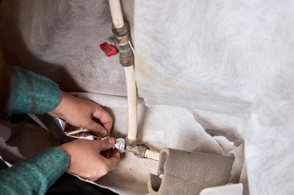 Close up of a plumber fixing a pipe